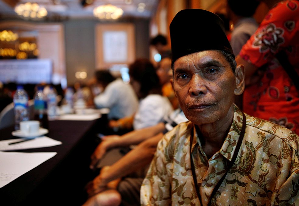 Abdurrashim, 72, poses for a photograph while attending a state-backed event on the controversial anti-communist purge of 1965 in Jakarta,
