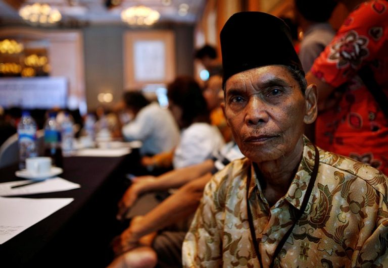 Abdurrashim, 72, poses for a photograph while attending a state-backed event on the controversial anti-communist purge of 1965 in Jakarta,